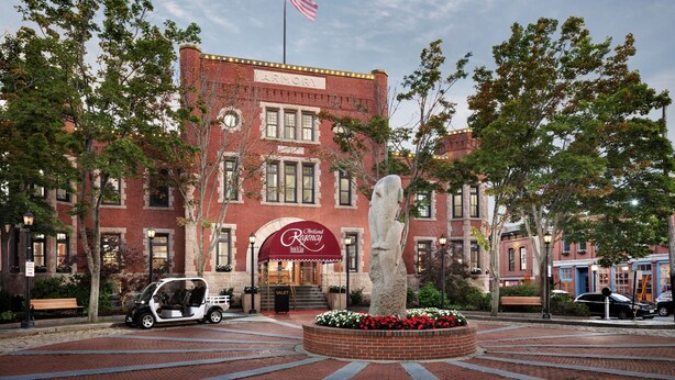 A brick building with a red awning labeled "Chateau Riverside."