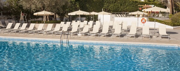 Outdoor pool, a rooftop pool, pool umbrellas