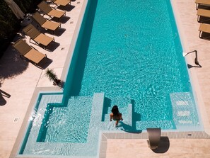 Seasonal outdoor pool, open 10:00 AM to 7:30 PM, pool loungers