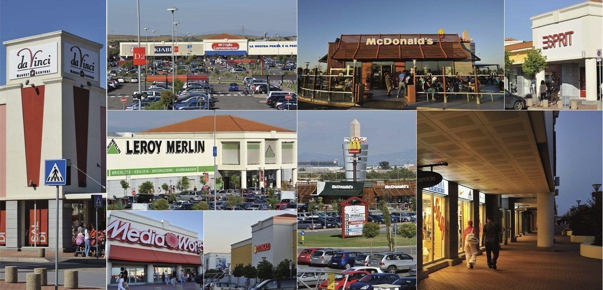 A variety of commercial buildings including a McDonald's, a MediaWorld store, and a Leroy Merlin store.