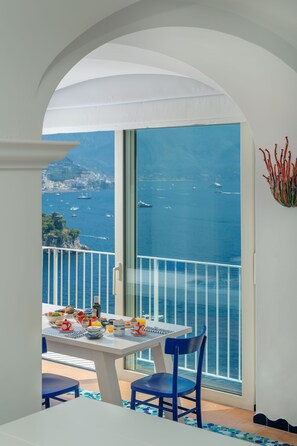 Enjoy a meal on the balcony with a view of the sea and boats.