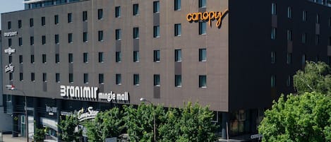 A modern building with a large sign for 'Branimir Mingle Mall' and 'canopy' on the side.