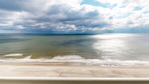 A beach with a clear view of the ocean and a sandy shoreline.