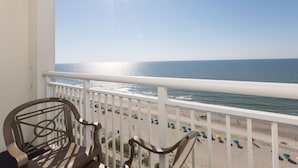 A balcony with a view of the ocean and beach.