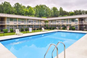 Una piscina al aire libre, sombrillas, tumbonas