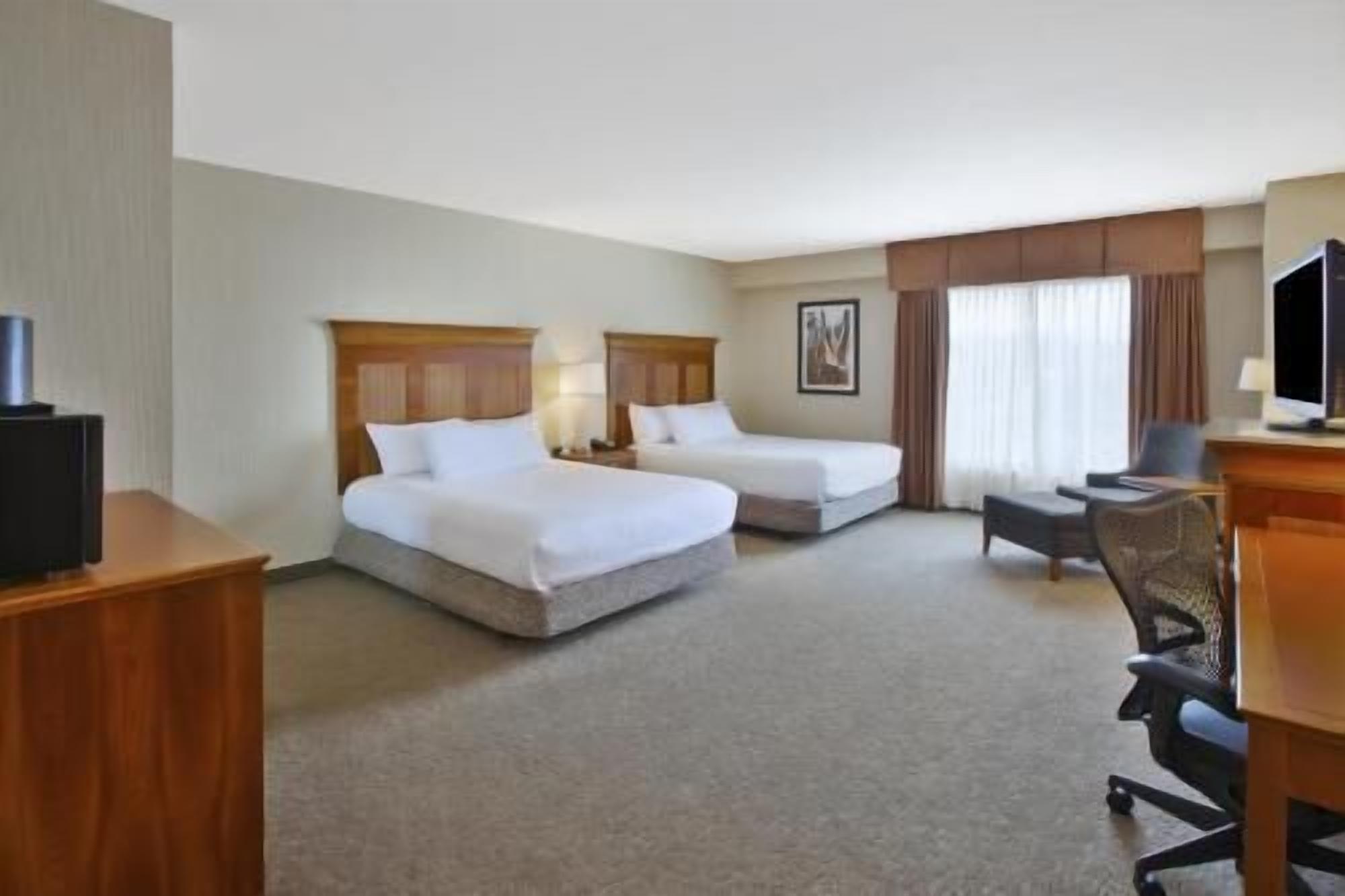 Hypo-allergenic bedding, desk, laptop workspace, blackout curtains