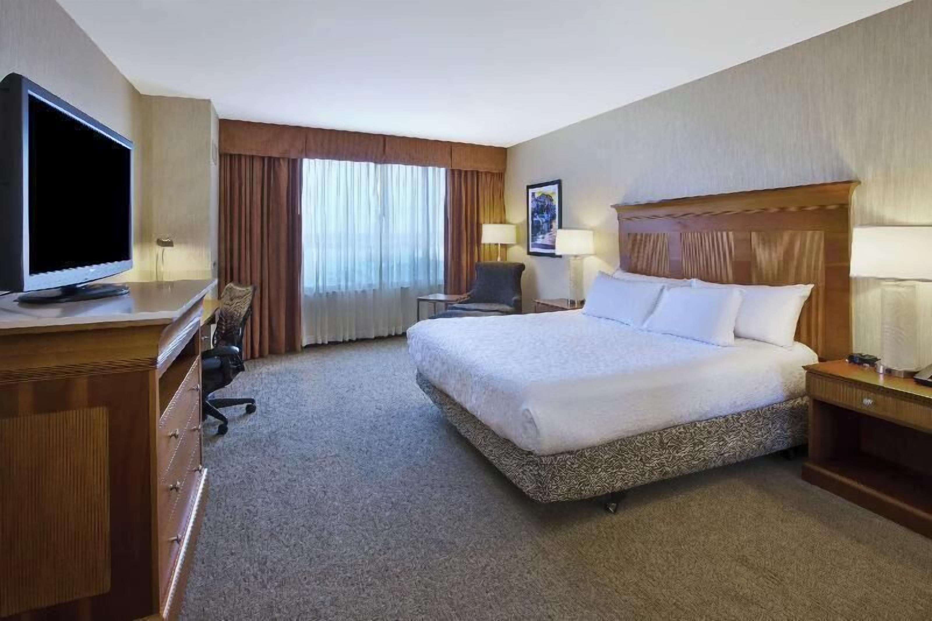 Hypo-allergenic bedding, desk, laptop workspace, blackout curtains