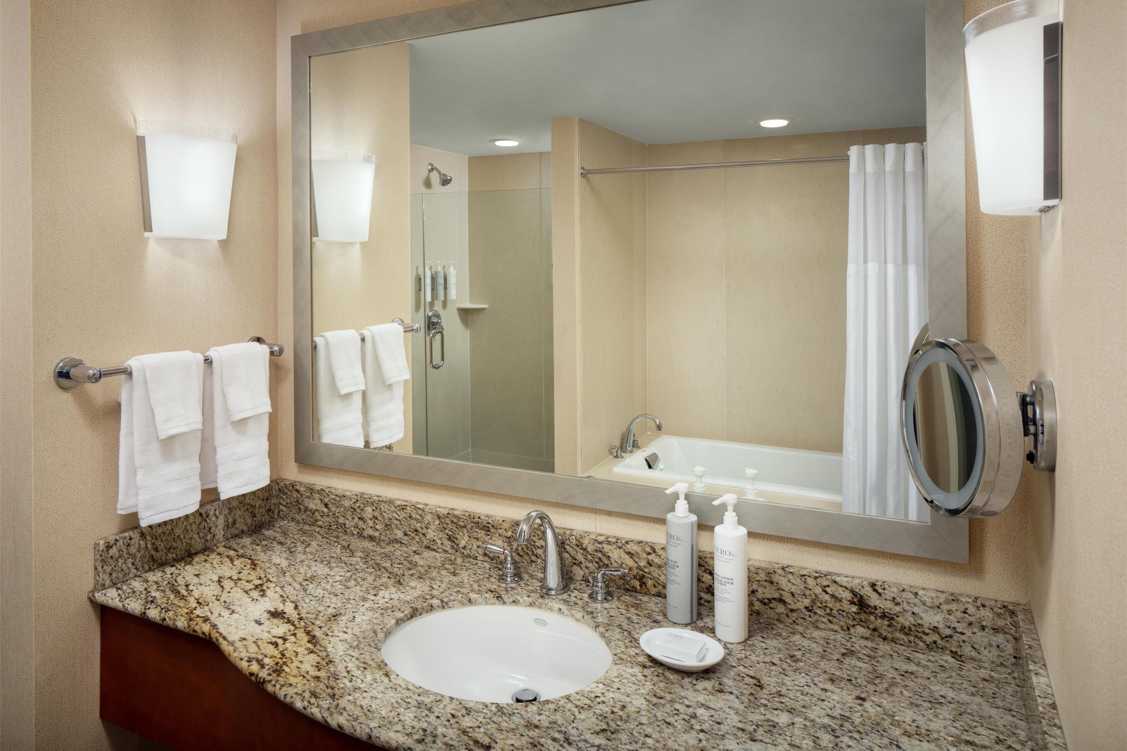 1 bedroom deluxe suite, 1 king bed with sofa bed, water view | bathroom | combined shower/bathtub, free toiletries, hair dryer, towels