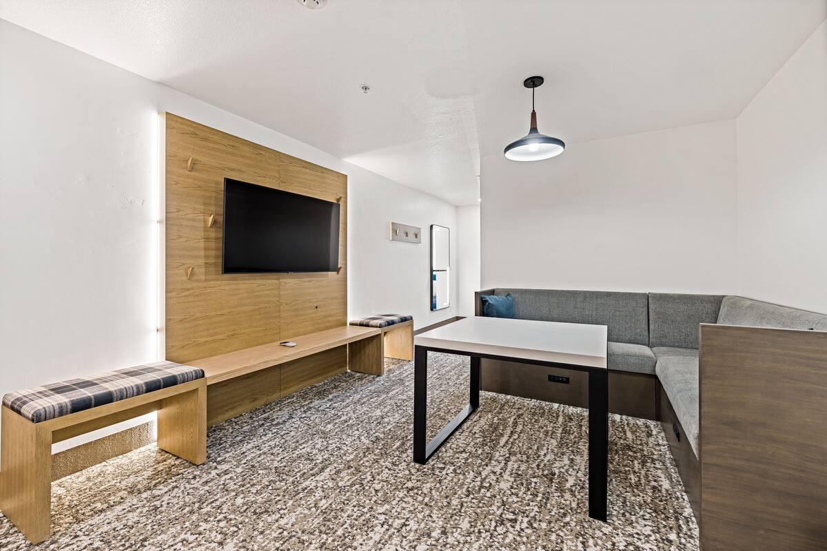 deluxe king suite with kitchenette | living area | tv