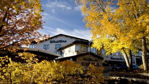 A building with a sign reading "Whistlers" and a pub sign below it.