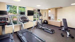 A gym with treadmills, an elliptical, a stationary bike, and free weights. - TownePlace Suites by Marriott Springfield (Springfield)