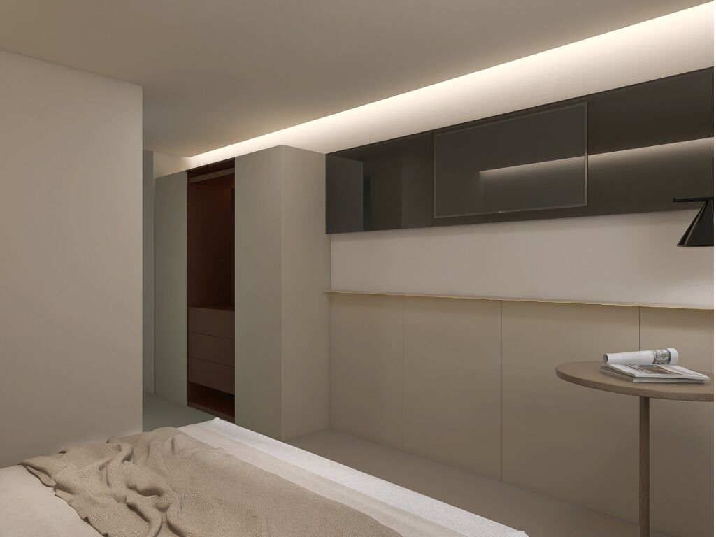 A modern bedroom with a bed, a bedside table, a mirror, and built-in storage.