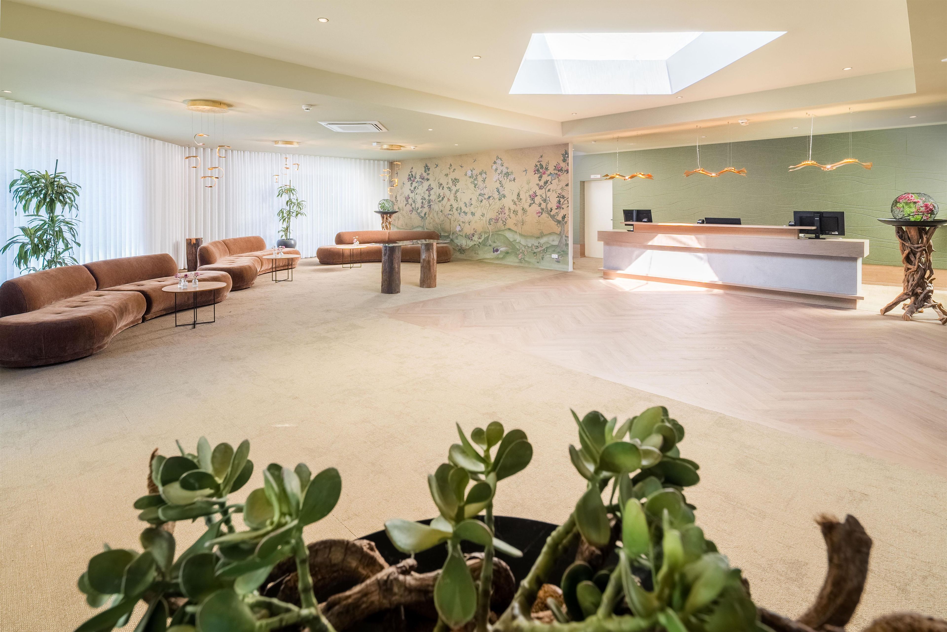A spacious living area with a sofa, coffee table, and a reception desk.
