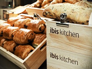 Wooden display cases labeled "ibis kitchen" containing various baked goods. - ibis Bilbao Barakaldo (Barakaldo)