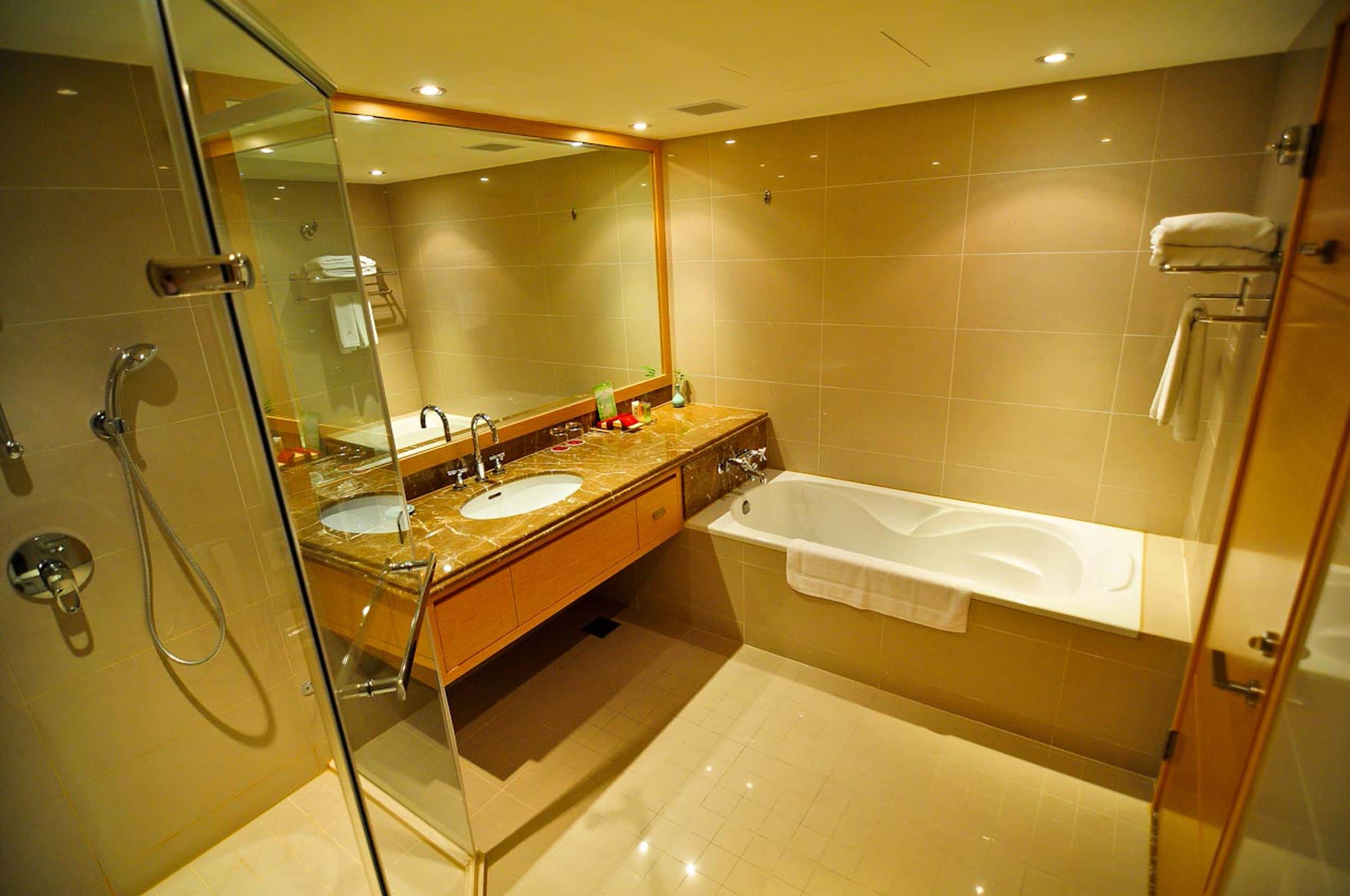 separate bathtub and shower, deep-soaking bathtub, hair dryer, towels