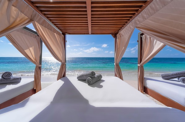 On the beach, white sand, beach umbrellas, beach towels