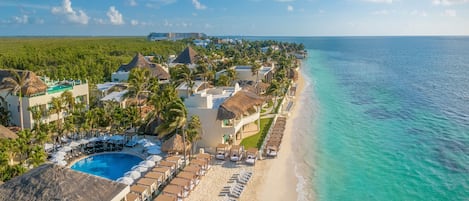 On the beach, white sand, beach umbrellas, beach towels