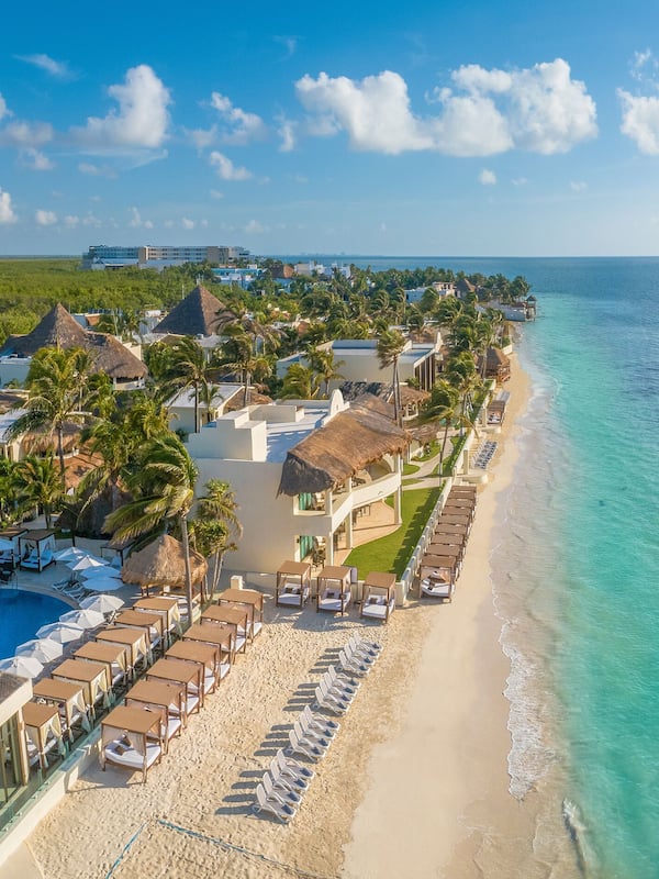 On the beach, white sand, beach umbrellas, beach towels