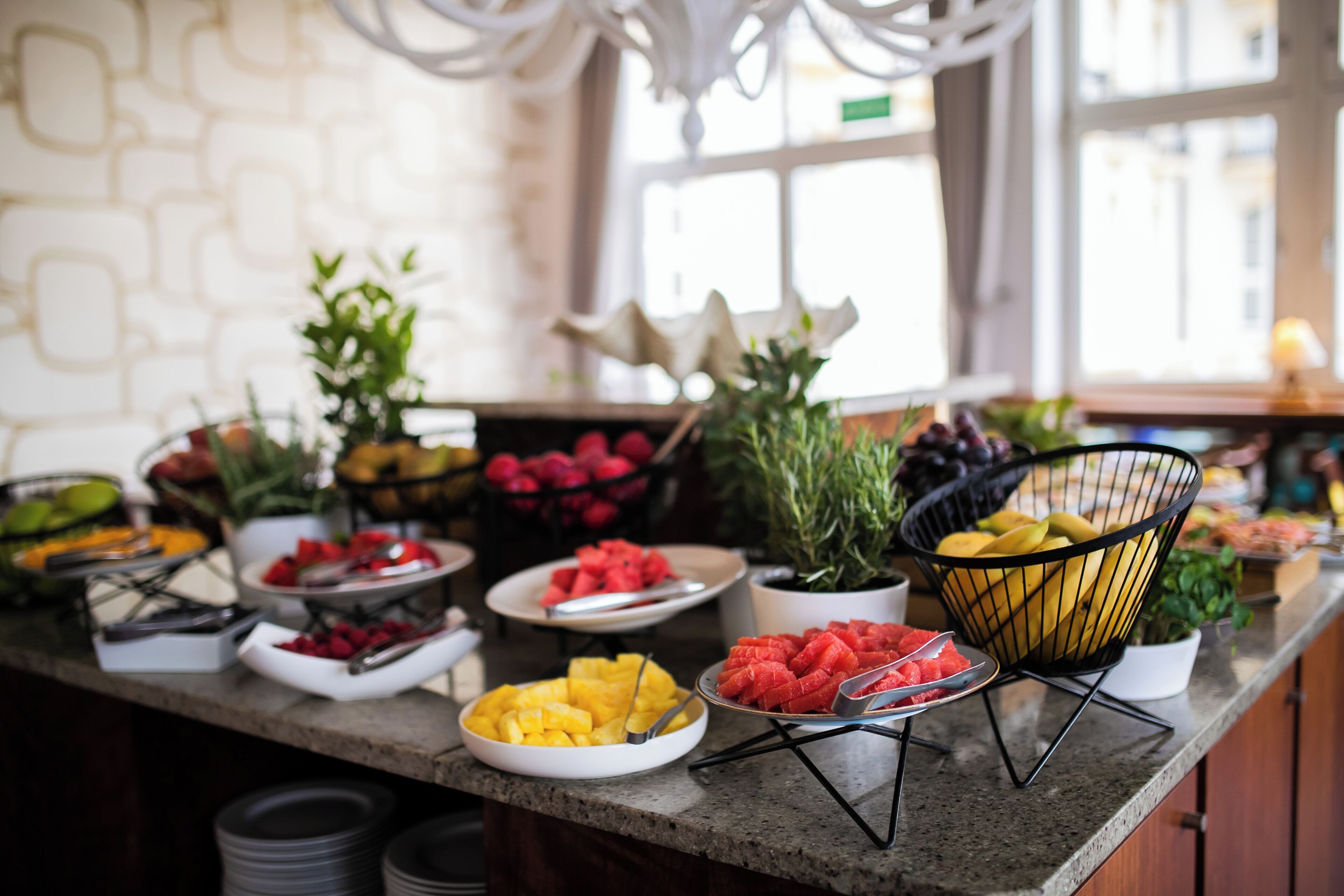 A buffet with various fruits and vegetables.