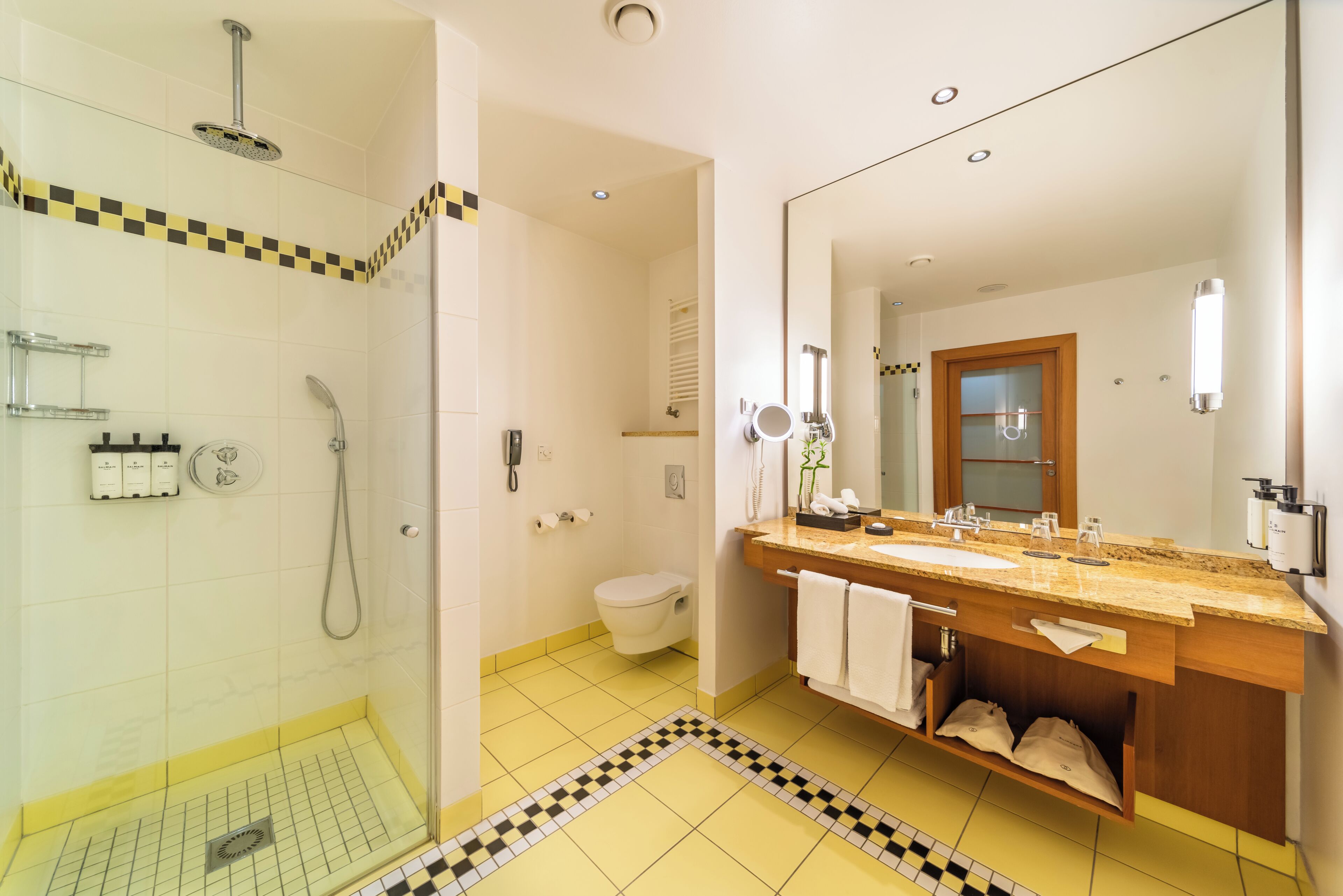 A bathroom with a shower, toilet, and sink.