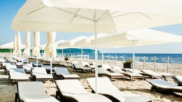 On the beach, sun-loungers, beach towels