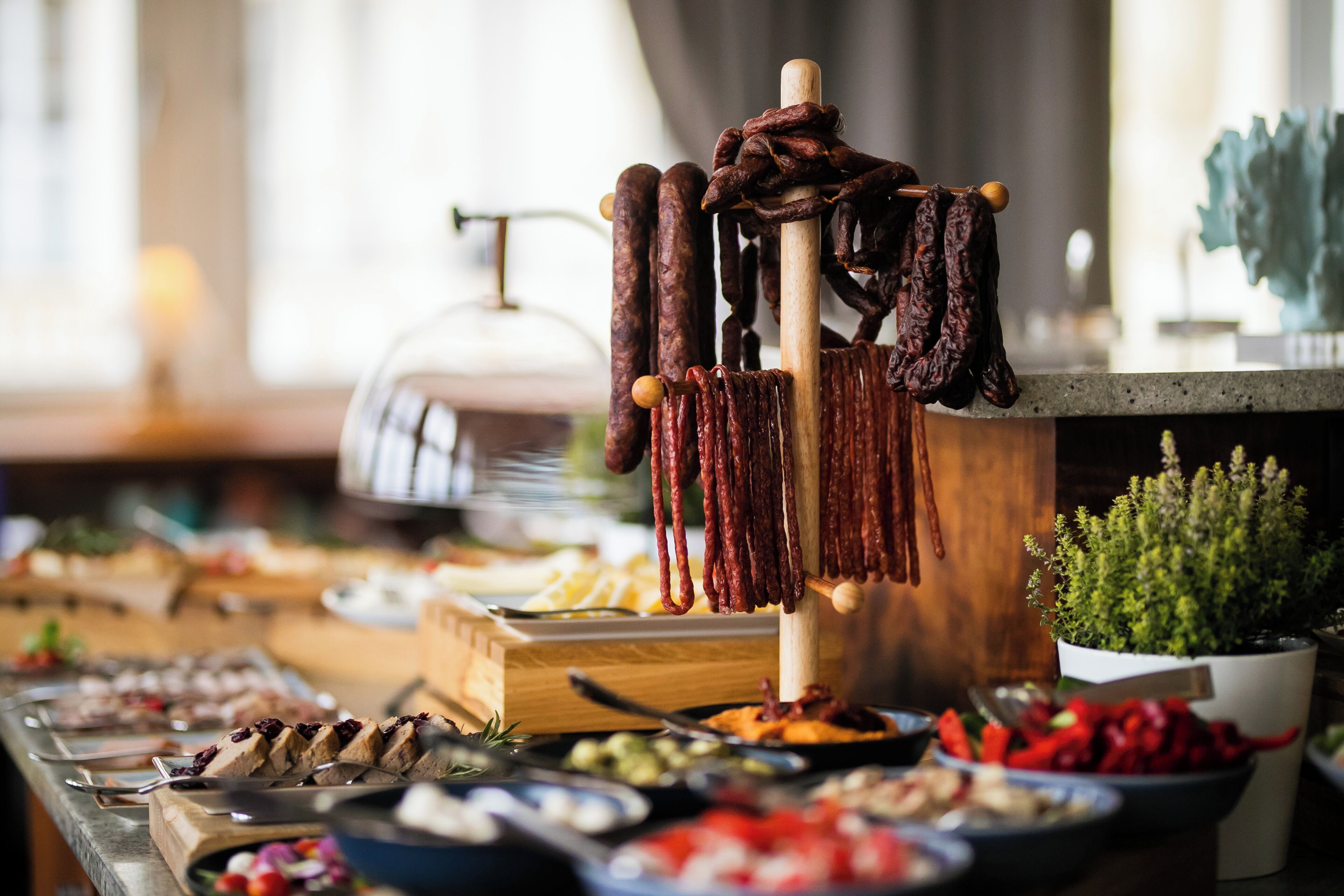 A buffet with various food items, including meats and vegetables.