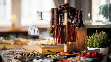 A buffet with various food items, including meats and vegetables.