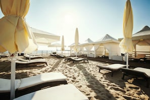 On the beach, sun loungers, beach towels