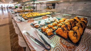 A buffet with various pastries and baked goods.