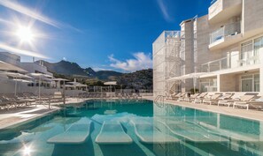 Seasonal outdoor pool, pool umbrellas, pool loungers