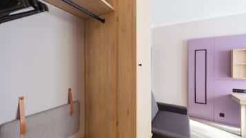 A compact room with a built-in bench, a small table, and a purple cabinet.