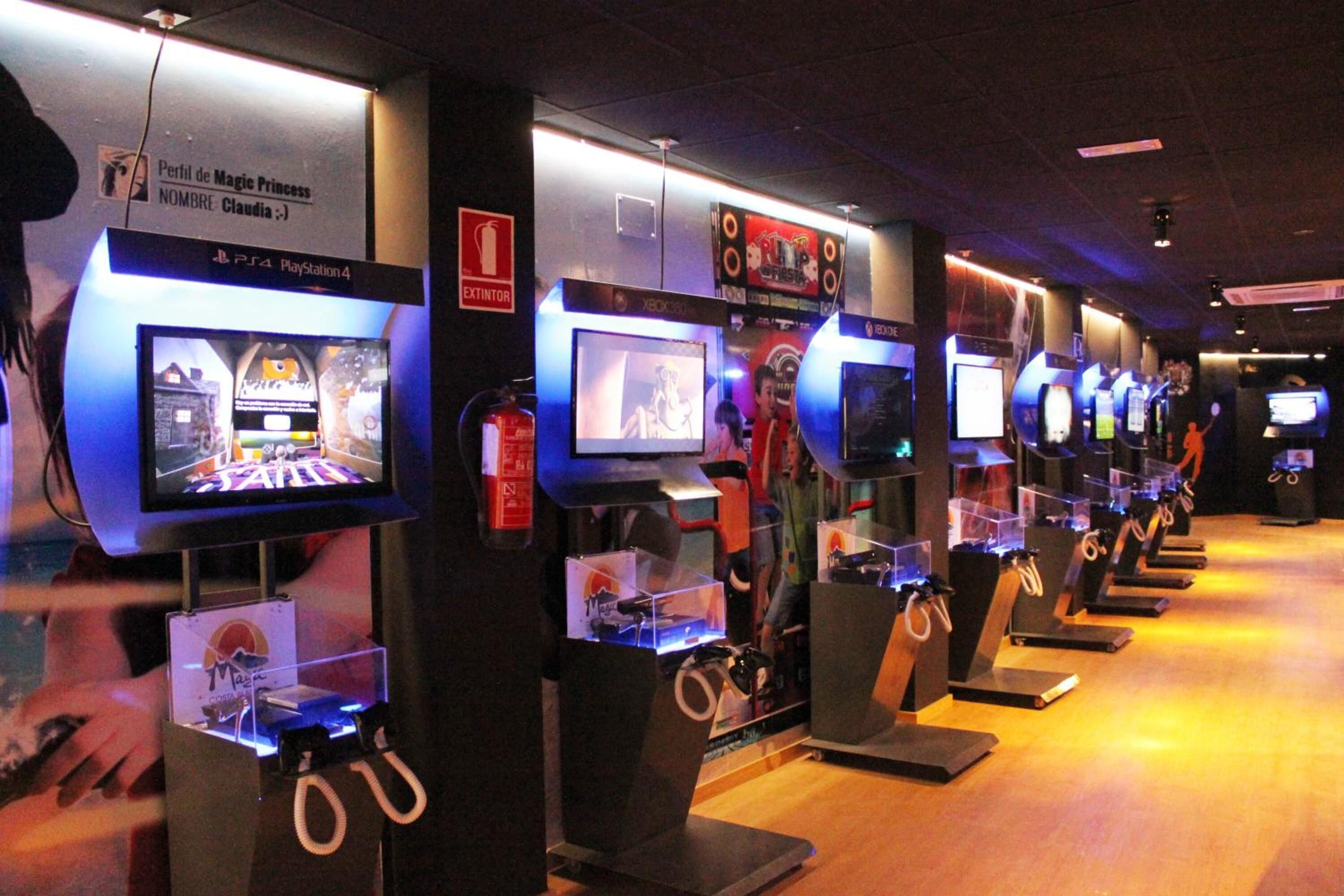 A row of gaming stations with multiple monitors, each with a clear plastic front and a black base.