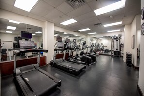 A gym with treadmills, elliptical machines, and weight equipment. - Campus Tower Suite Hotel (Edmonton)