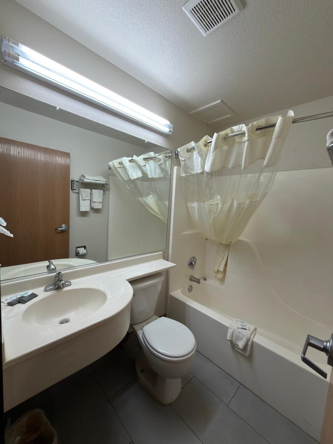 A bathroom with a sink, toilet, and bathtub.