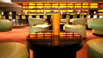 A bar area with multiple seating options and a well-lit, organized bar counter.
