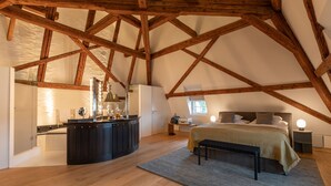 A bedroom with a large bed, a bedside table, a nightstand, and a window. - Seehotel Sonne (Kuesnacht)