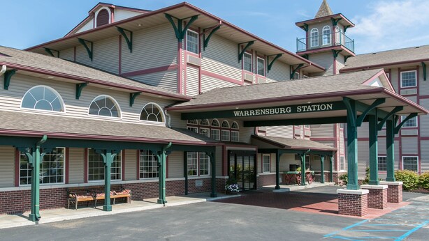 A historic train station with a covered waiting area, benches, and a small tower. - Comfort Inn Warrensburg Station (Warrensburg)