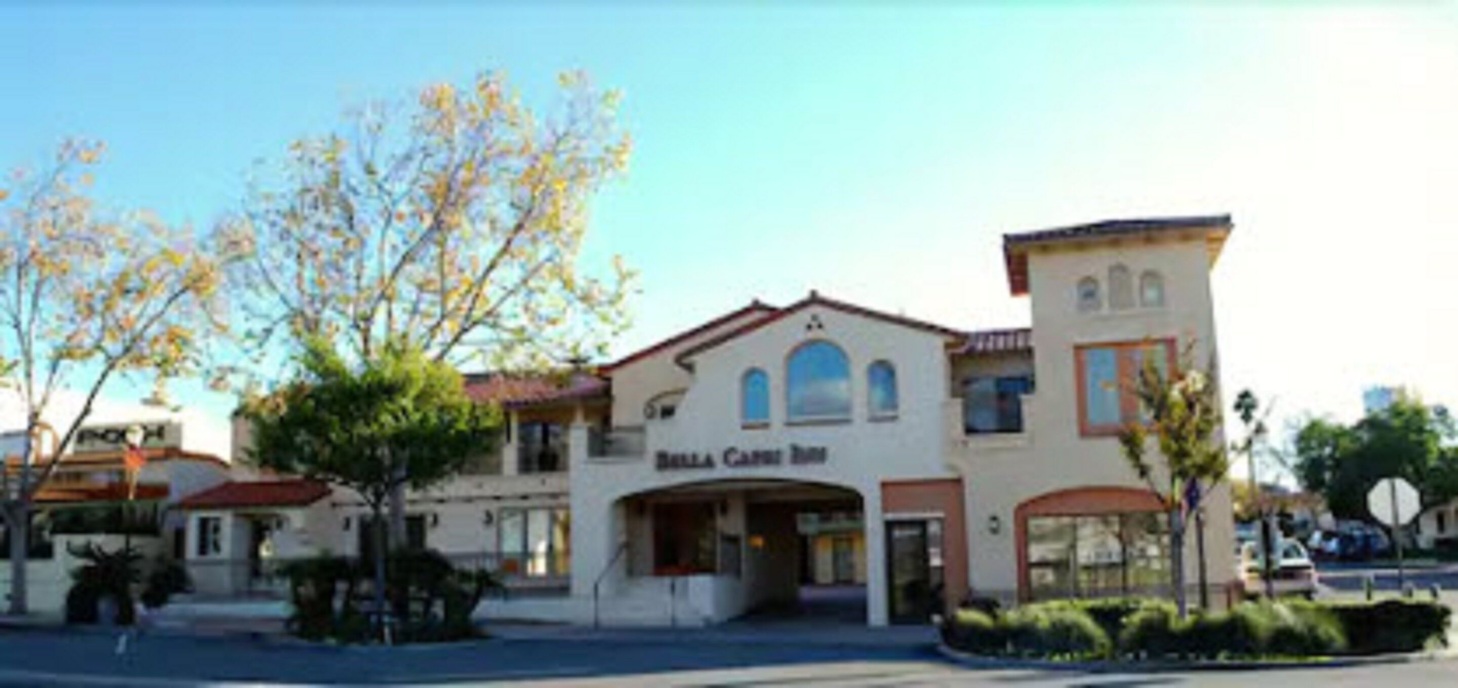 A two-story building with a central entrance and a sign that reads "Bella Carrot Bistro."