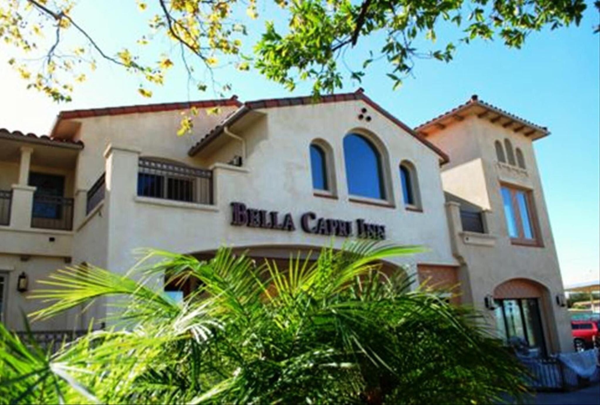 A two-story building with the sign "Bella Cava Inn" on the facade.