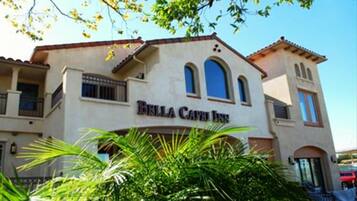 A two-story building with the sign "Bella Cava Inn" on the facade.