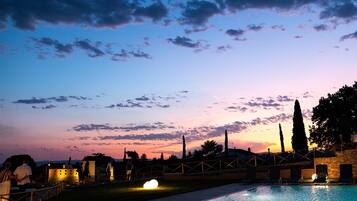 Seasonal outdoor pool, open 9:30 AM to 7:00 PM, pool umbrellas