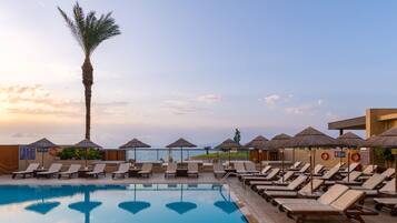 Outdoor pool, open 9 AM to 7 PM, pool umbrellas, pool loungers