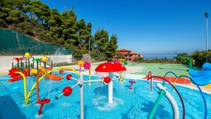 A water play area with various colorful structures and a pool. - Atrium Hotel (Kassandra)