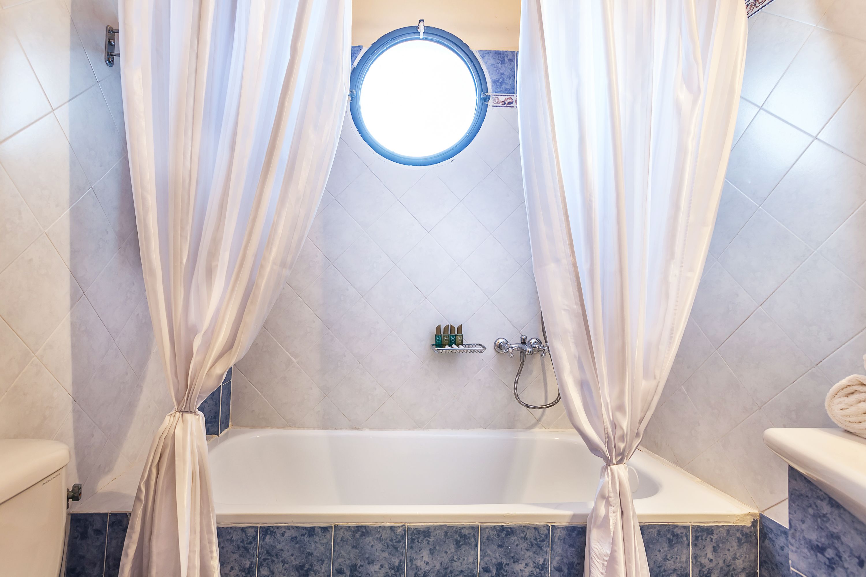 A bathroom with a bathtub, a shower, and a toilet.