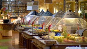 A buffet with various food items and a sign indicating a variety of tapas and cold meats. - Magic Aqua Rock Gardens (Benidorm)