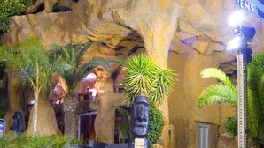 A building with a large rock-like structure and the words "MAGIC ROCKS" at the top. - Magic Aqua Rock Gardens (Benidorm)
