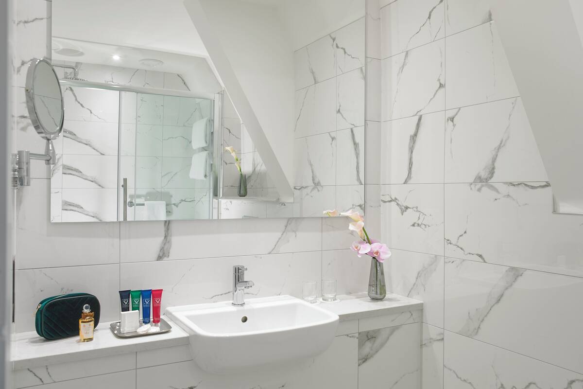 junior studio suite | bathroom | designer toiletries, hair dryer, towels, soap