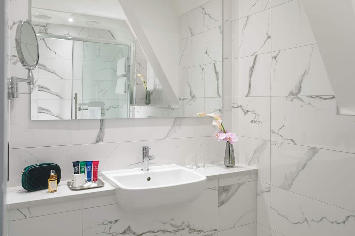 Junior Studio Suite | Bathroom | Designer toiletries, hair dryer, towels, soap
