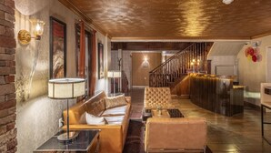 A spacious lobby with a leather sofa, a glass coffee table, and a reception desk. - Canyons Boutique Hotel, a Canyons Collection Property (Kanab)