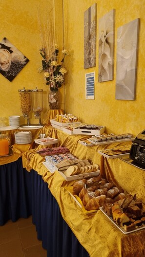 A buffet setup with various food items, a coffee machine, and a sign indicating local disposal instructions. - Ai Tigli (Langhirano)